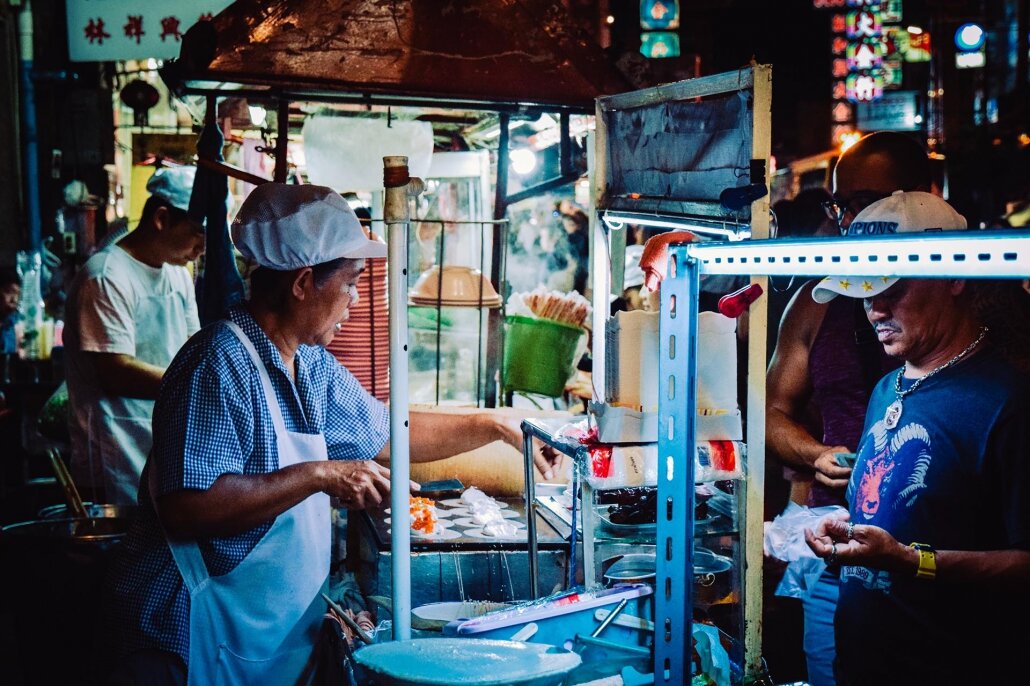 A shopkeeper working on one of the best Michelin star street food stalls in Bangkok.
